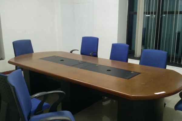 A professional meeting room at Infinity Business Centre designed for smaller teams, featuring an oval conference table and comfortable chairs, ideal for collaborative sessions and client discussions.
