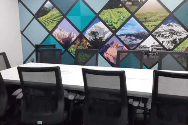 Vibrant conference room with a striking wall mural and a long white table, providing a creative and inspiring space at Infinity Business Centre.